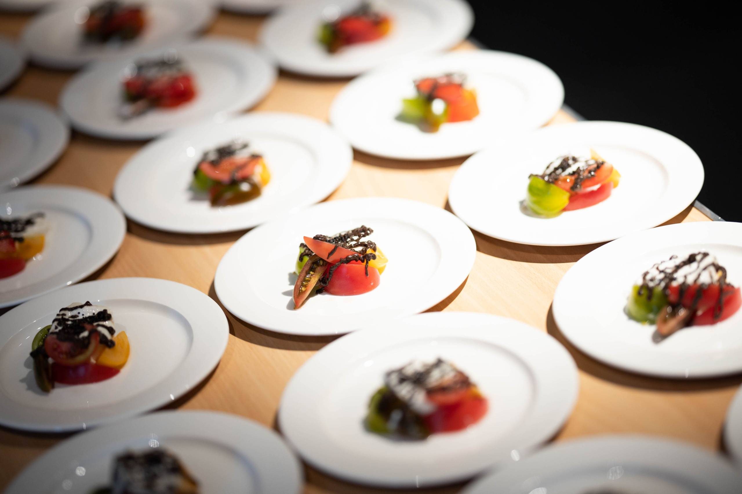 This image shows a selection of small plates with colourful canapes