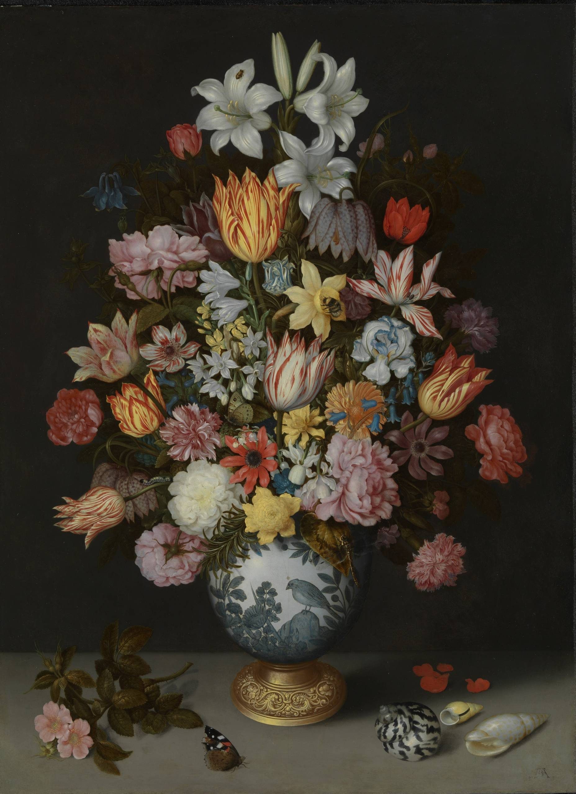 A still life painting of a vibrant flower arrangement. The vase contains a lush bouquet of various flowers in shades of red, pink, white, and yellow. The flowers include tulips, roses, lilies, and other blooms. The arrangement is set against a dark background, and there are a few small details like a butterfly and shells scattered around the base.