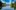 CV-scaled-aspect-ratio-2-1 A large blue lake surrounded by luscious green trees.